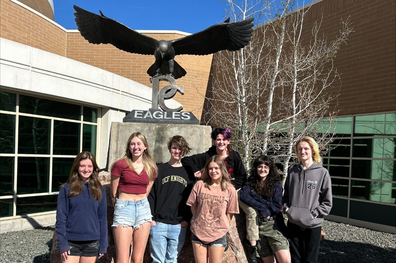 Students posed in front of the eagle statue